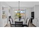 Inviting dining room with modern light fixture, balcony access, and views of the surrounding neighborhood at 2325 Windmill Pkwy # 1124, Henderson, NV 89074