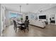Bright living area with a dining table, couch, and balcony access, providing seamless indoor-outdoor living at 2325 Windmill Pkwy # 1124, Henderson, NV 89074