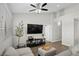 Cozy living room featuring a mounted TV, ceiling fan, and comfortable seating, perfect for relaxation at 2325 Windmill Pkwy # 1124, Henderson, NV 89074