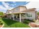 Lovely backyard featuring a covered patio, lush lawn, and charming landscaping at 2418 Brockton Way, Henderson, NV 89074