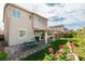 Inviting backyard with a covered patio, picnic table, lush lawn, and colorful flower beds, ideal for outdoor enjoyment at 2418 Brockton Way, Henderson, NV 89074