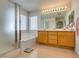 Bright bathroom with a soaking tub, glass-enclosed shower, double sink vanity and ample natural light at 2418 Brockton Way, Henderson, NV 89074