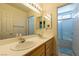 Well-lit bathroom with double sinks, a large mirror, and a shower/tub combination, offering convenience and style at 2418 Brockton Way, Henderson, NV 89074