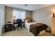 Comfortable bedroom with a desk area, neutral tones, and soft lighting, perfect for work or relaxation at 2418 Brockton Way, Henderson, NV 89074