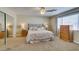 Spacious bedroom with neutral decor, featuring a comfortable bed, mirrored closet, and ample natural light at 2418 Brockton Way, Henderson, NV 89074