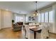 Living and dining area featuring hardwood floors, plantation shutters, and natural light at 2418 Brockton Way, Henderson, NV 89074