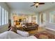 Inviting living room featuring hardwood floors, plantation shutters, and comfortable seating at 2418 Brockton Way, Henderson, NV 89074