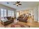 Inviting living room featuring hardwood floors, plantation shutters, and comfortable seating at 2418 Brockton Way, Henderson, NV 89074
