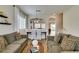 Bright living room with hardwood floors, an open dining area, and neutral decor at 2418 Brockton Way, Henderson, NV 89074