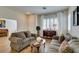Cozy living room featuring hardwood floors, plantation shutters, and comfortable seating at 2418 Brockton Way, Henderson, NV 89074