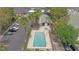 Aerial view of community pool and parking lot with surrounding trees at 2471 Old Forge Ln # 103, Las Vegas, NV 89121