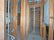 A view of an unfinished basement showing open stud walls, pipes, and electrical boxes ready for remodel at 2471 Old Forge Ln # 103, Las Vegas, NV 89121