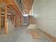 Unfinished basement showing a framed wall, access to the garage, and stairs to the upper level at 2471 Old Forge Ln # 103, Las Vegas, NV 89121
