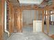 An unfinished basement showcasing studs, water pipes, and open access to a staircase for a complete remodel at 2471 Old Forge Ln # 103, Las Vegas, NV 89121