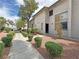 Apartment exterior featuring well-maintained landscaping, gravel and shrubs, with a lovely sidewalk at 2471 Old Forge Ln # 103, Las Vegas, NV 89121