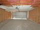 Unfinished garage showing exposed beams and garage door; ready for customization and your personal touch at 2471 Old Forge Ln # 103, Las Vegas, NV 89121