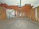 Unfinished garage with a water heater, electrical panel, and exposed framework; primed for renovation at 2471 Old Forge Ln # 103, Las Vegas, NV 89121