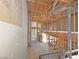 The interior construction site reveals wood framing and the layout of the first and second floors at 2471 Old Forge Ln # 103, Las Vegas, NV 89121