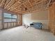 A view of an unfinished living room featuring exposed beams, a window with partial furnishings; ready to remodel at 2471 Old Forge Ln # 103, Las Vegas, NV 89121