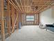 Partially finished living room with exposed stud walls, a new subfloor, and a window for customization at 2471 Old Forge Ln # 103, Las Vegas, NV 89121