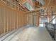 Unfinished room shows wood framing, exposed ceiling vents, and a partial view to an adjacent space at 2471 Old Forge Ln # 103, Las Vegas, NV 89121