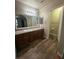 Bathroom featuring vanity with granite countertop and modern sink, with an adjacent door for added convenience at 2700 N Rainbow Blvd # 1084, Las Vegas, NV 89108