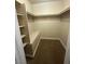 Walk-in closet with built-in shelving and bench seating, maximizing storage space and functionality at 2700 N Rainbow Blvd # 1084, Las Vegas, NV 89108