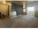 Living room with carpet, slider door to balcony, and entry to kitchen at 2700 N Rainbow Blvd # 1084, Las Vegas, NV 89108
