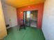 A relaxing patio features a rocking chair, vibrant green floor, and a sliding glass door at 2700 N Rainbow Blvd # 1084, Las Vegas, NV 89108
