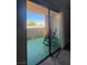 A serene outdoor patio features a comfortable rocking chair and sliding glass door at 2700 N Rainbow Blvd # 1084, Las Vegas, NV 89108