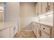 Wet bar featuring white cabinets, countertops and ample storage space at 3004 Canton Hills St, Henderson, NV 89052