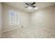 An airy bedroom with tile floors, shuttered windows, and a ceiling fan with lights at 3004 Canton Hills St, Henderson, NV 89052