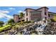 Exterior view of a clubhouse showcasing a waterfall feature and well-manicured landscaping at 3004 Canton Hills St, Henderson, NV 89052