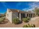 Stucco home featuring a tile roof, desert landscaping, and a covered patio at 3004 Canton Hills St, Henderson, NV 89052
