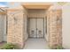 Inviting front entry with decorative security doors, sconces and attractive stone pillars at 3004 Canton Hills St, Henderson, NV 89052