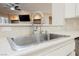 Modern kitchen sink and faucet, with view to living room at 3004 Canton Hills St, Henderson, NV 89052