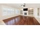 Bright living room with wood floors, recessed lighting, and fireplace with shelving at 3004 Canton Hills St, Henderson, NV 89052