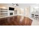 Spacious living room with hardwood flooring, fireplace, and views into the kitchen at 3004 Canton Hills St, Henderson, NV 89052