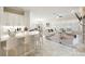 Open concept living space with white cabinets, bar seating, and a seamless flow into the dining and living areas at 3004 Canton Hills St, Henderson, NV 89052