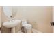 Powder room with a stand alone sink and decorative round mirror and a toilet at 3004 Canton Hills St, Henderson, NV 89052
