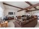 Open living room featuring a fireplace, tile flooring, and exposed beams at 304 S Crestline Dr, Las Vegas, NV 89107