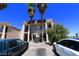 Two-story apartment complex with palm trees in front and two parking cars at 3616 Thomas Ave, North Las Vegas, NV 89030
