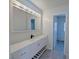 Bathroom with a white vanity, drawers and shelves, and a large mirror at 3667 Descanso St, Las Vegas, NV 89121