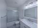 Bathroom features a shower over tub and single sink vanity with white marble top at 3667 Descanso St, Las Vegas, NV 89121