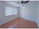 This bedroom is bright with natural light, wood floors, and a ceiling fan at 3667 Descanso St, Las Vegas, NV 89121