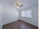 Bedroom featuring laminate floors, a ceiling fan, and large windows for natural light at 3667 Descanso St, Las Vegas, NV 89121