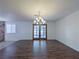 Open dining room with dark wood floors, a chandelier, and french doors, creating an elegant dining space at 3667 Descanso St, Las Vegas, NV 89121