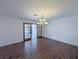 Open dining room with dark wood floors, a chandelier, and french doors, creating an elegant dining space at 3667 Descanso St, Las Vegas, NV 89121