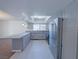 Bright open kitchen with stainless steel appliances, gray cabinets and an island at 3667 Descanso St, Las Vegas, NV 89121