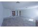 Open living area featuring tile floors, neutral walls, and access to a hallway, creating a versatile living space at 3667 Descanso St, Las Vegas, NV 89121